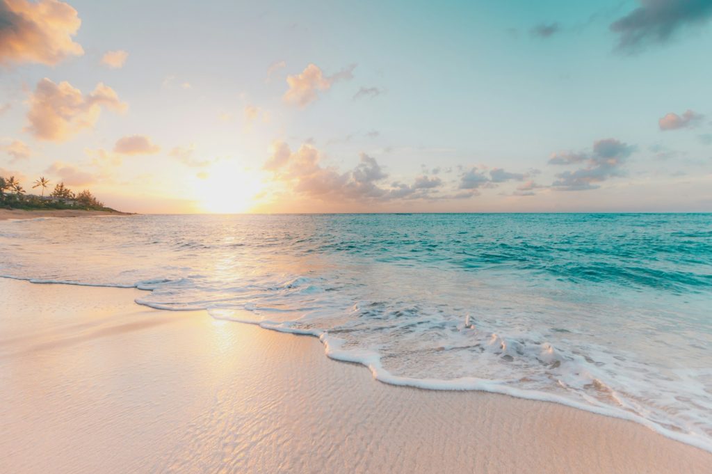 Golden sunset over calm water on the beach